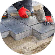 Man working on interlock driveway