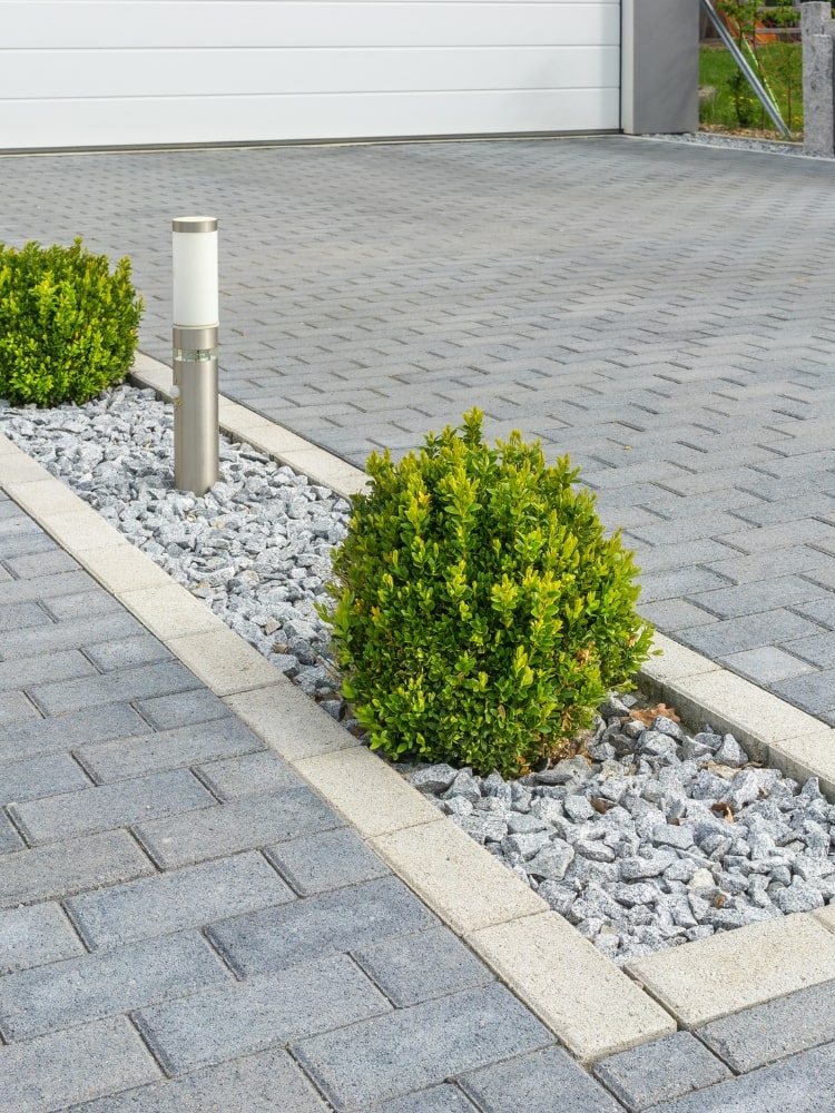 interlocking stone driveway shrub and light